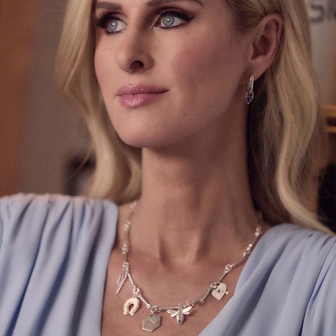 Nicky Hilton in a blue dress wearing a charm necklace