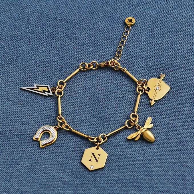 a gold charm bracelet on a blue background