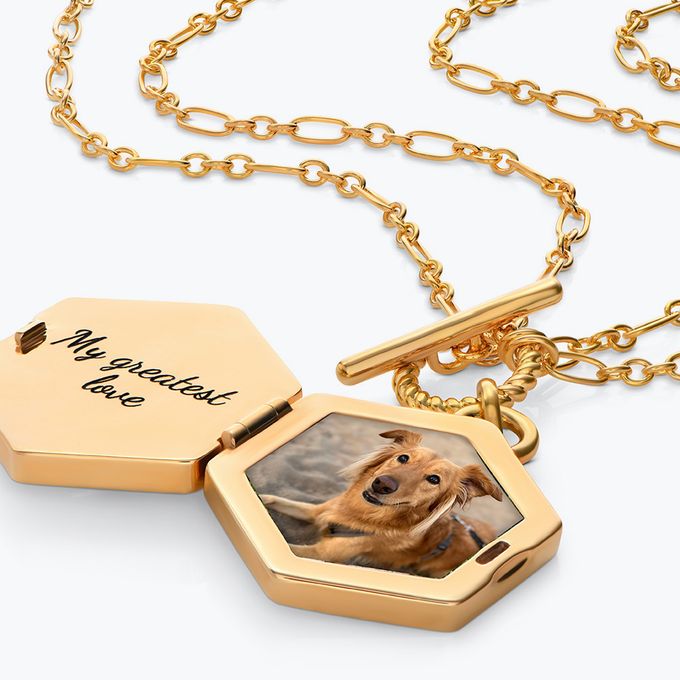 a gold locket with a picture of a dog inside