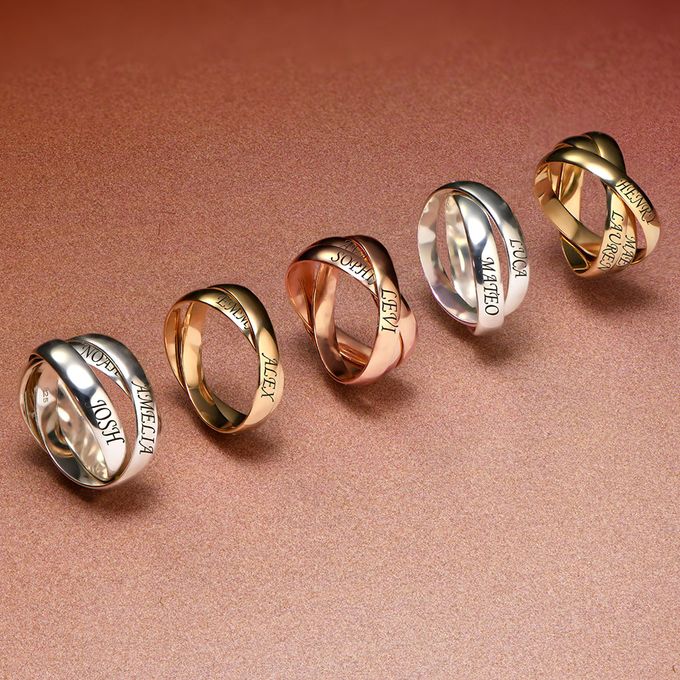 a row of rings in silver, yellow gold and rose gold with names on them