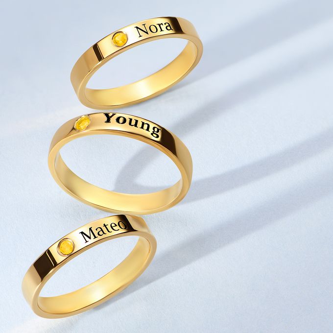 3 gold stacking rings with yellow stones and name engravings