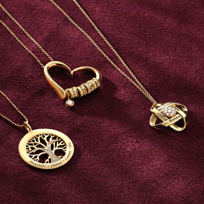 a couple of necklaces sitting on top of a purple cloth