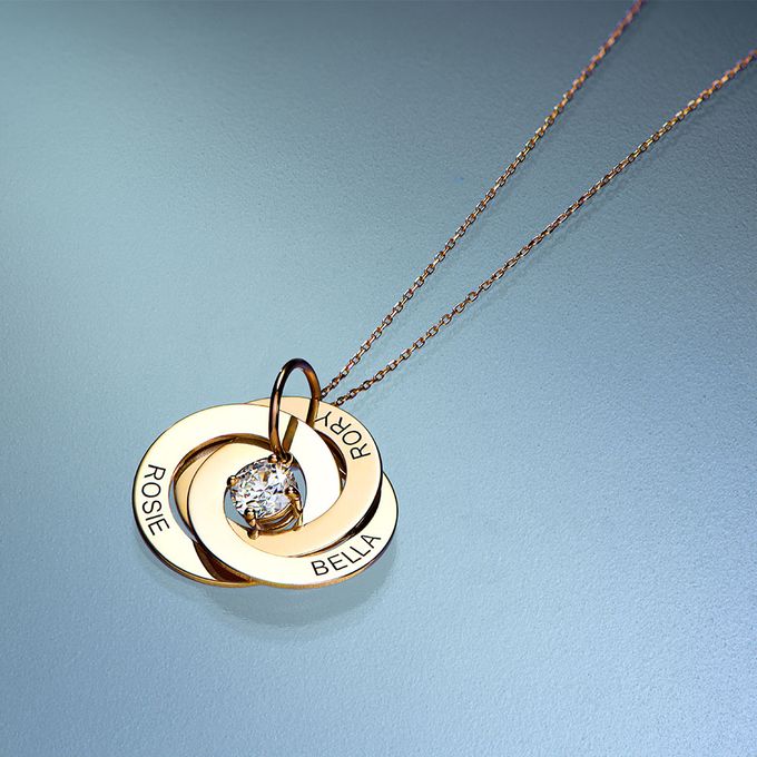 Russian Ring Necklace with 1CT Lab Diamond in 14K Solid Yellow Gold a couple of necklaces that are sitting on a table