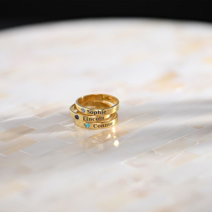 a couple of gold rings sitting on top of a table