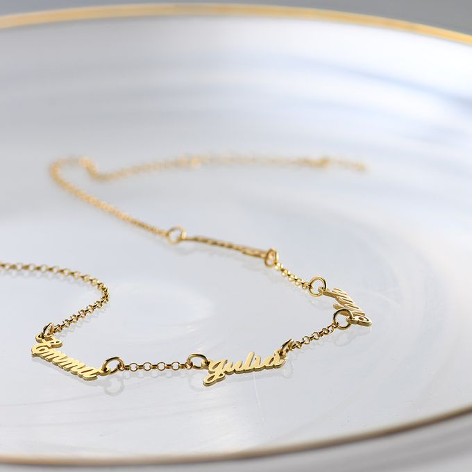 a white plate with a gold necklace on it