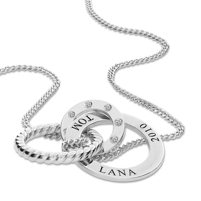 a silver necklace with two names on them