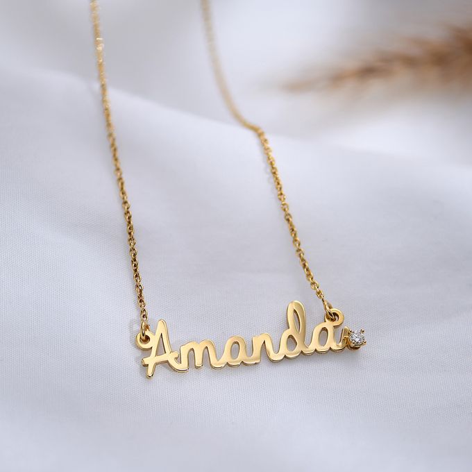 a gold necklace with the word amanda on it