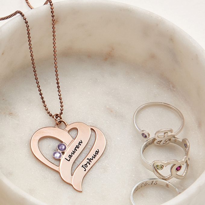 a couple of rings and a necklace in a bowl