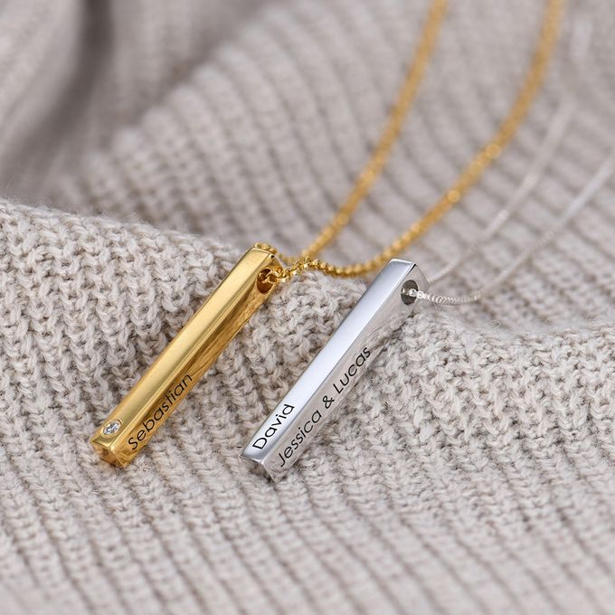 a couple of necklaces sitting on top of a sweater