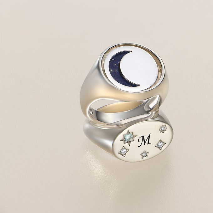 a silver ring with a crescent and stars on it