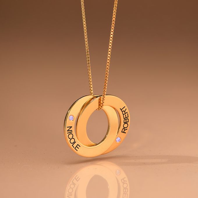 a gold necklace with two interlocked circles