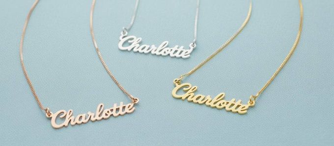 three personalized necklaces with the name Charlotte on a blue background