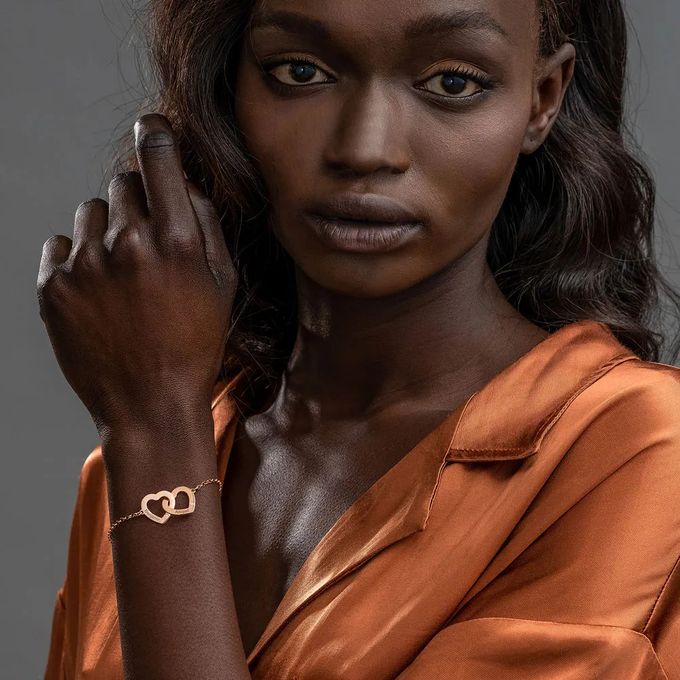 Rose Gold Plated Claire Interlocking Adjustable Hearts Bracelet Woman wearing a rose gold plated bracelet with interlocking hearts on her wrist