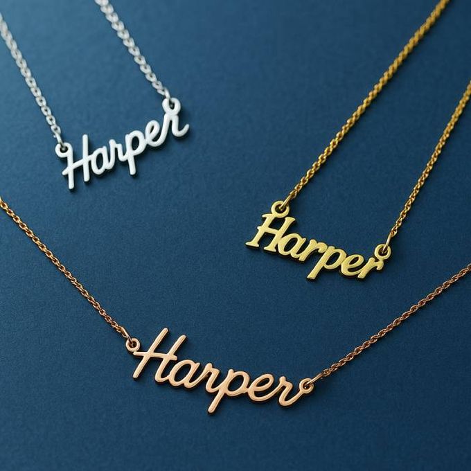 three personalized Harper name necklaces on a blue surface