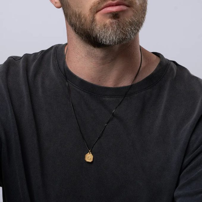 a man with a beard wearing a black shirt