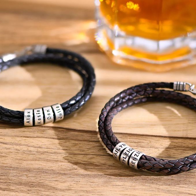 Stock Image of a braided leather bracelet with inscribed silver beads 