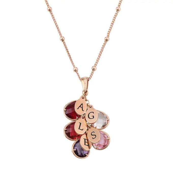 a gold plated necklace with five charms on it