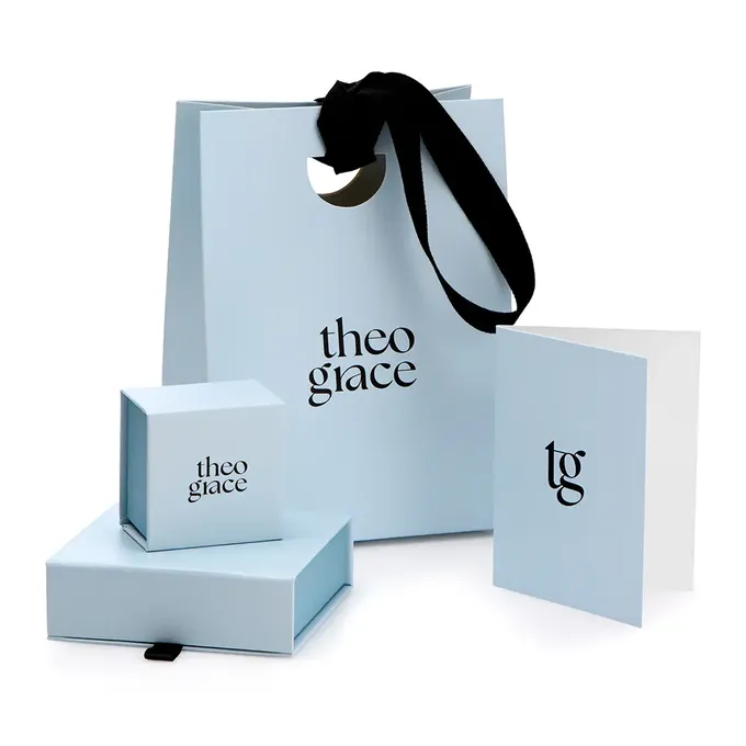 a white bag with a black ribbon on top of it