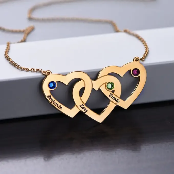 three heart shaped necklaces with names on it