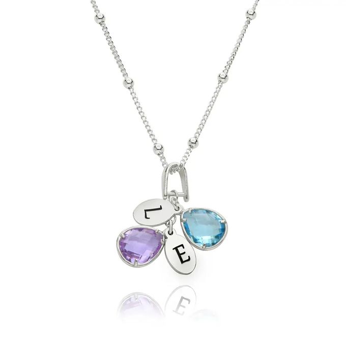 a personalized necklace with two birthstones and two initials
