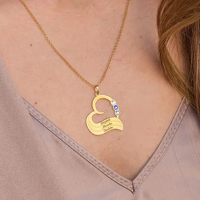 a woman wearing a gold necklace with three names