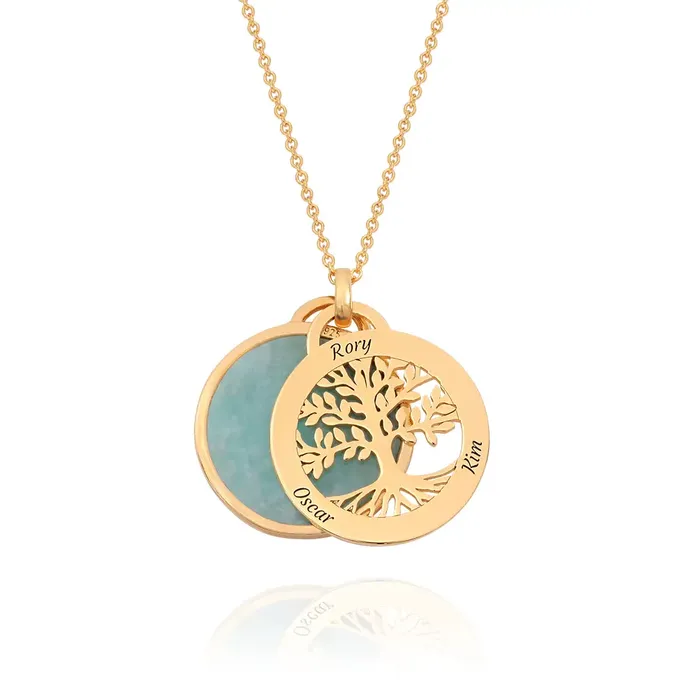 a gold plated necklace with a tree of life on it