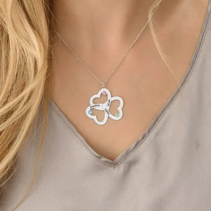a close up of a woman wearing a heart necklace