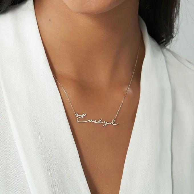 White gold necklace with a signature-style name pendant that reads "Evelyn"