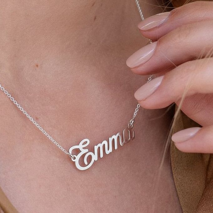 a close up of a person wearing Emma necklace