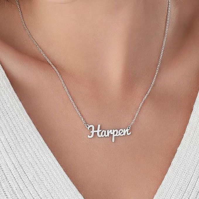 Harper London Name Necklace in Sterling Silver a woman wearing a silver necklace with the word harper on it