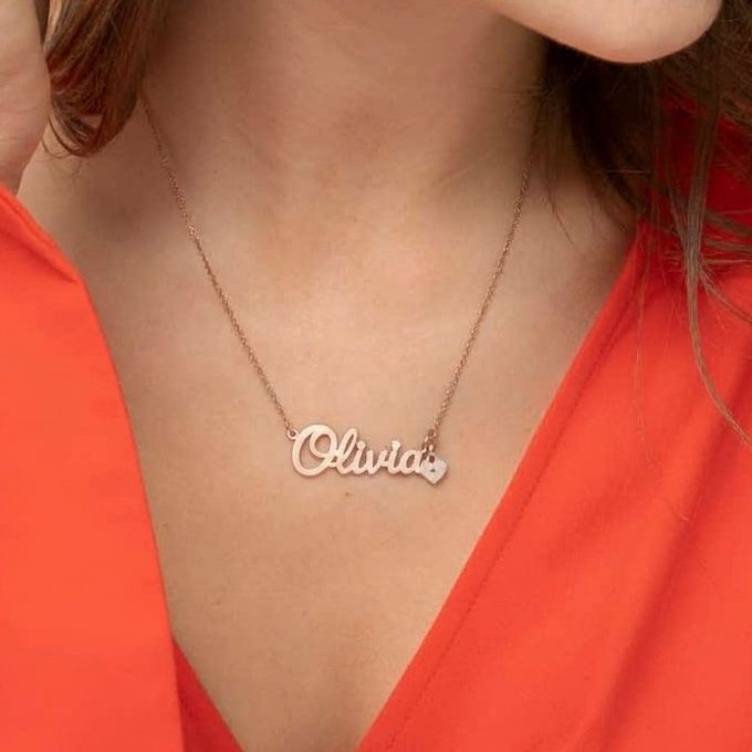 Olivia Sweetheart Name Necklace in Rose Gold Plating a woman wearing a name necklace with the name Olivia on it