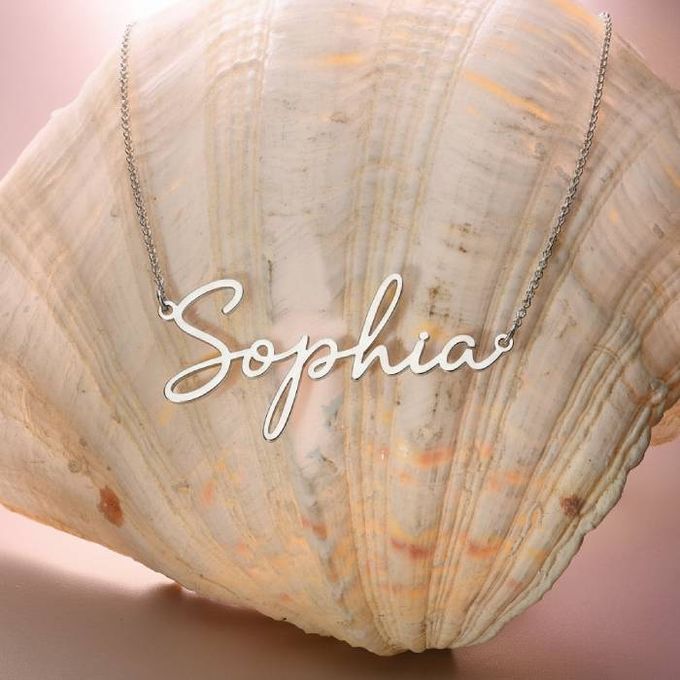 a sea shell with a name necklace with the name Sophia on it