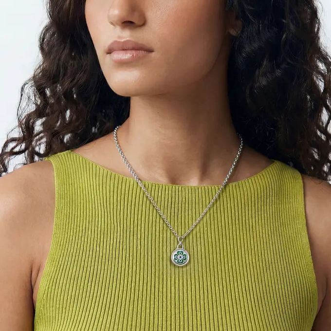 Little Ray of Sunshine Charm Necklace a woman wearing a green top and a clover necklace