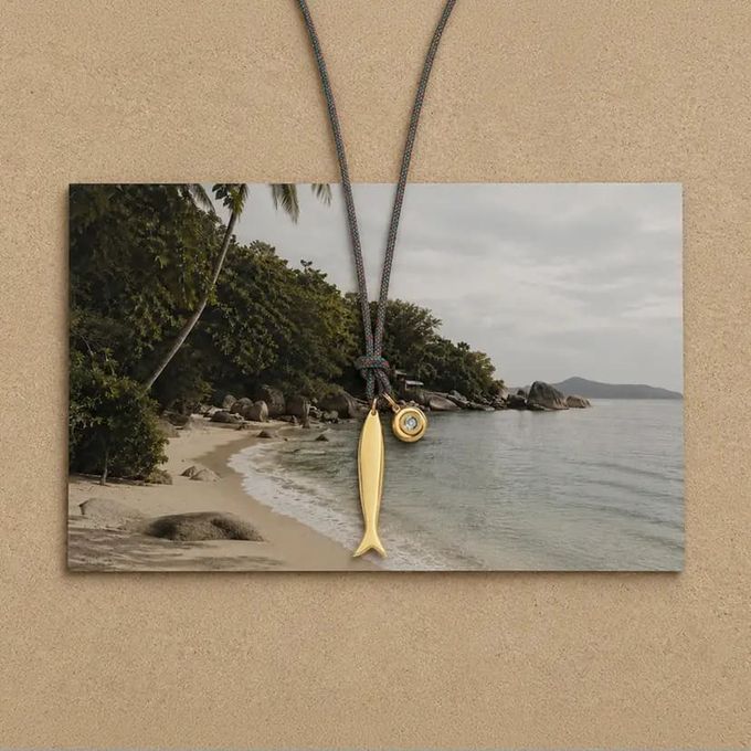 Lucky Catch Fish Adjustable Cord Necklace in Silver lucky fish charm necklace on a costal picture