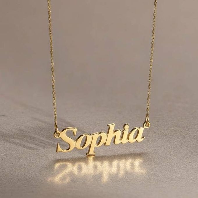 a gold necklace with the word sophia on it