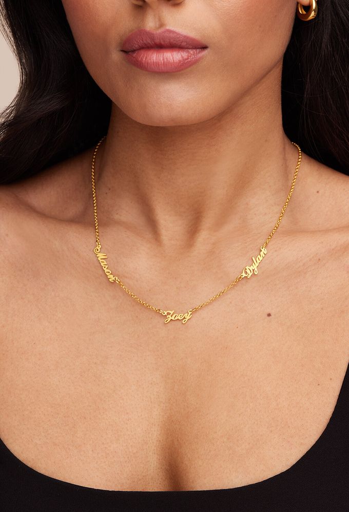 Heritage Multiple Name Necklace in 18K Gold Plating a close up of a woman wearing a name necklace