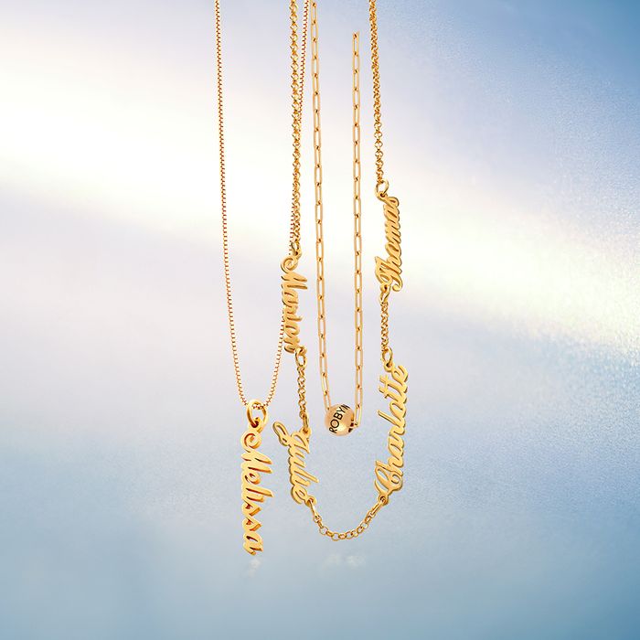 3 Gold necklaces hanging on a blue background