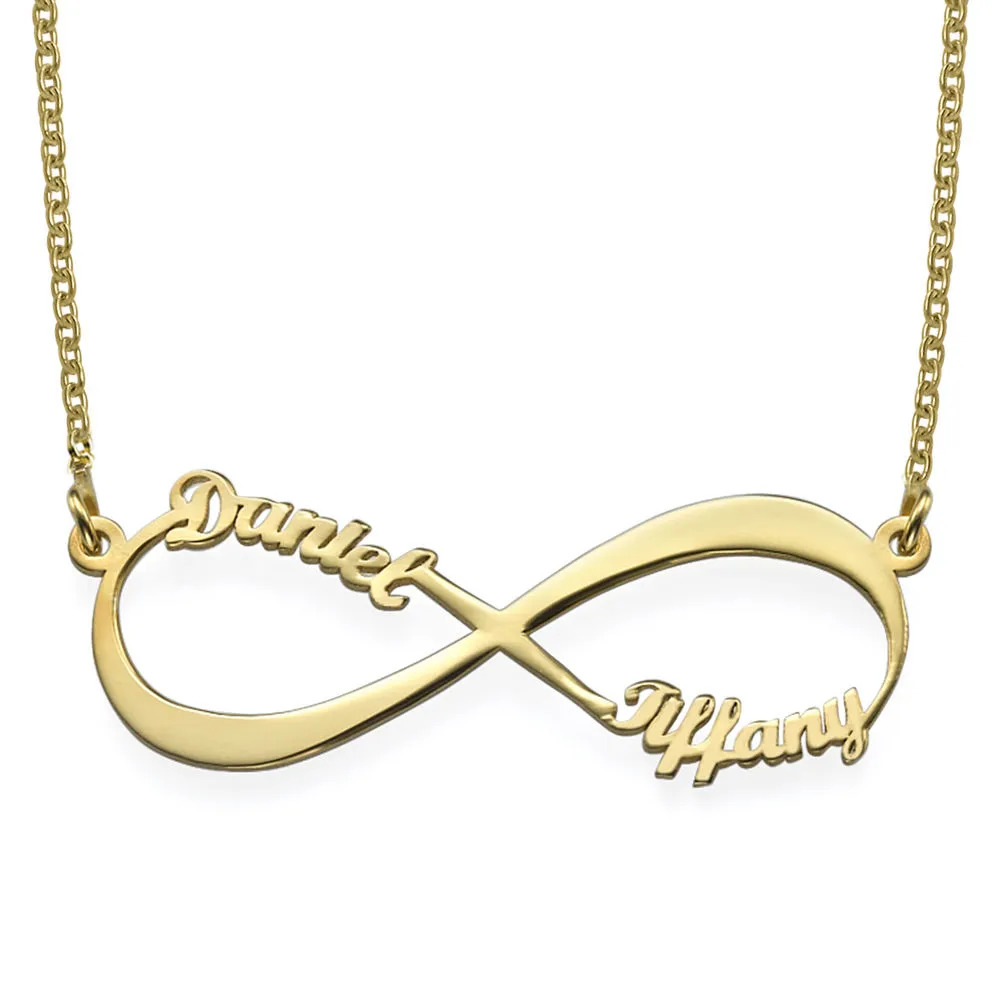 Stock image of a gold infinity sign-shaped necklace with names in cursive