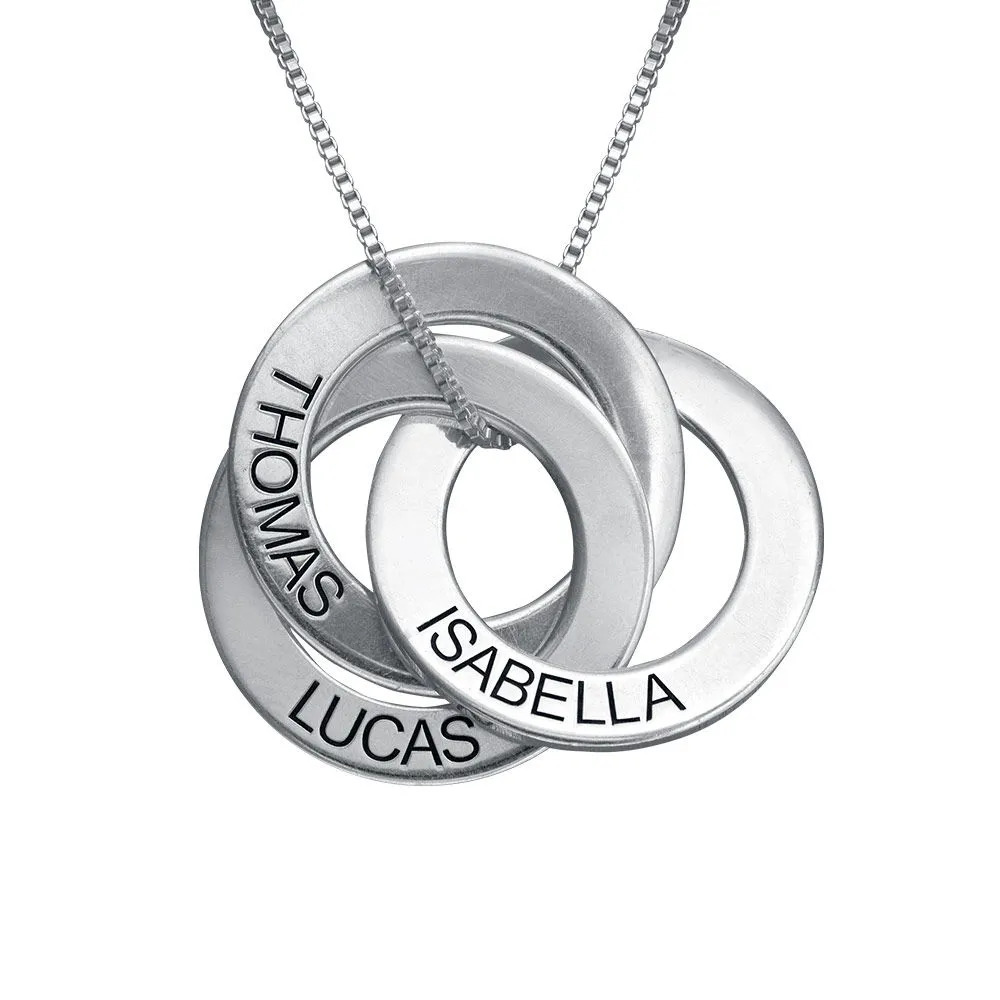 Stock image of a silver necklace with a Russian ring inscribed pendant
