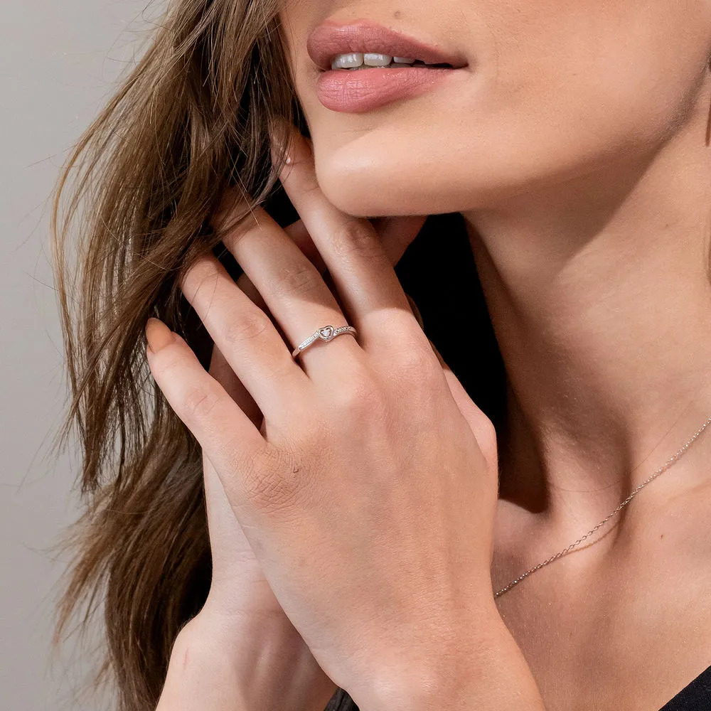 Woman wearing a sterling silver ring with a diamond on her middle finger 