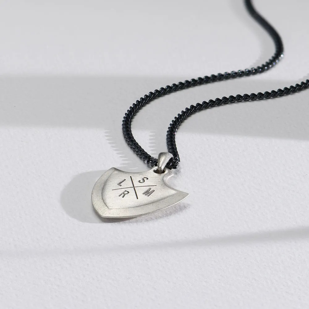 Necklace with a silver shield-shaped engraved pendant with initials