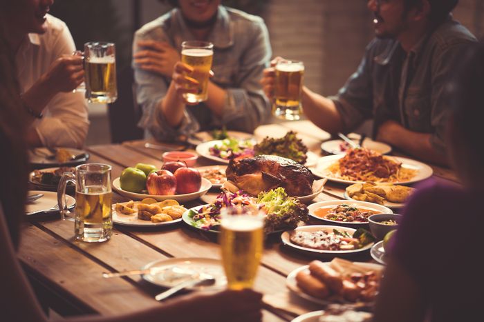 a group of people drinking beer and eating food