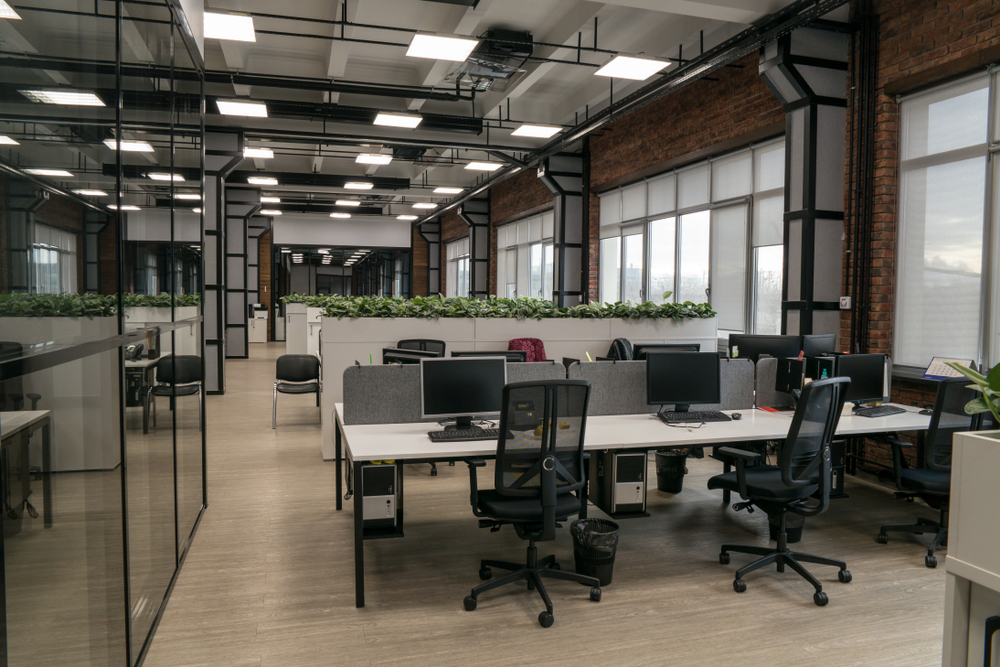 Open office plan layout with shared desks to maximize space efficiency