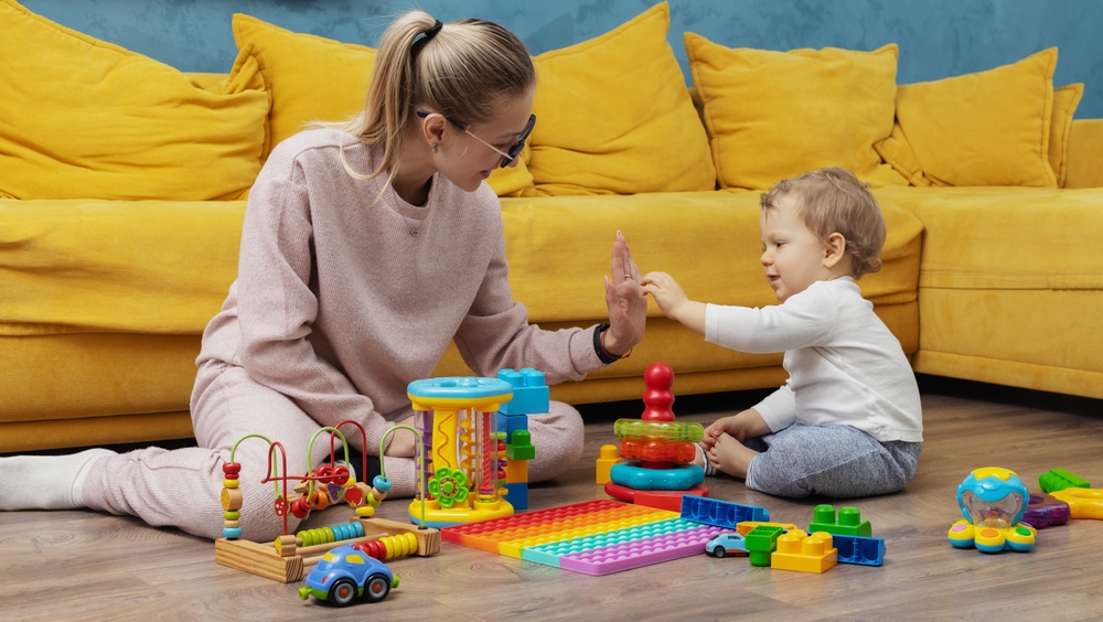 Mother and child playing with toys on the floor