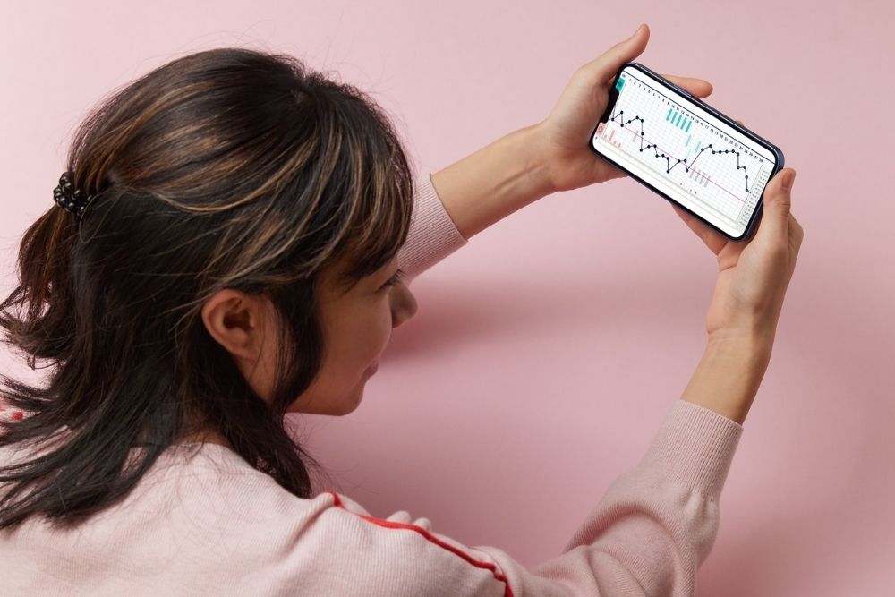 a woman holding a cell phone up to her face