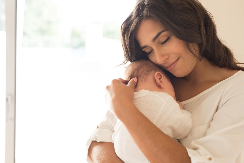 a woman holding a baby in her arms