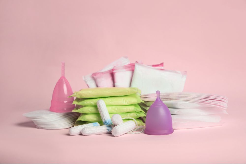 a pile of white and pink items on a pink background