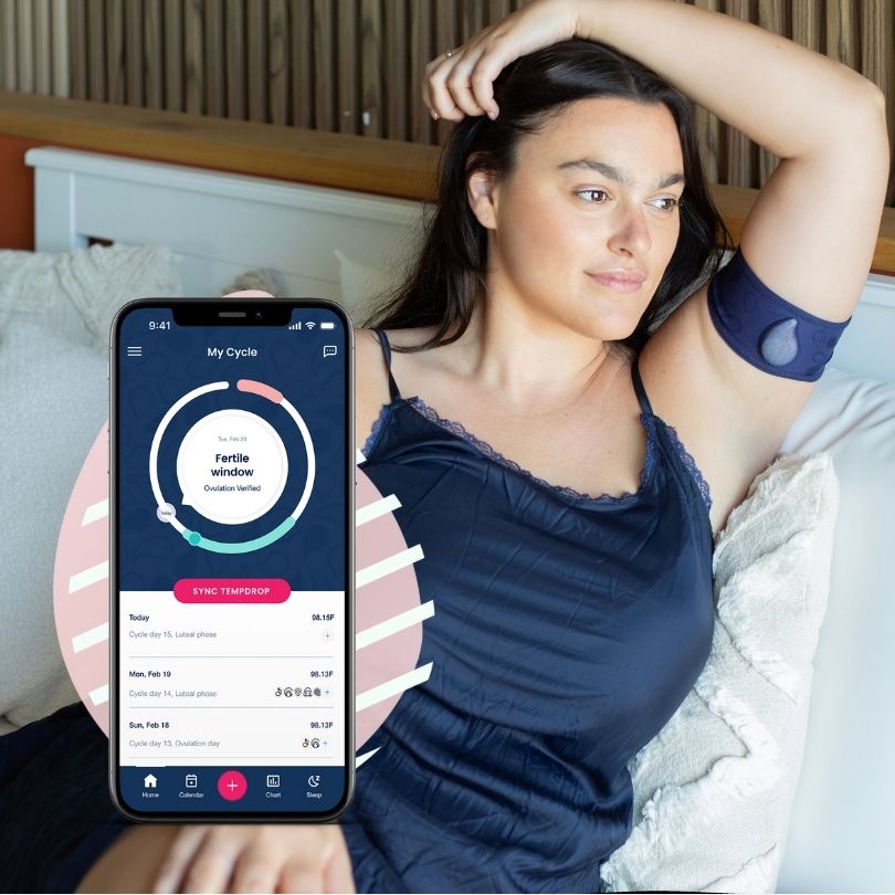 a woman sitting on a couch holding a cell phone