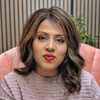a woman sitting in a chair with a red lipstick on her lips