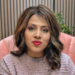 a woman sitting in a chair with a red lipstick on her lips